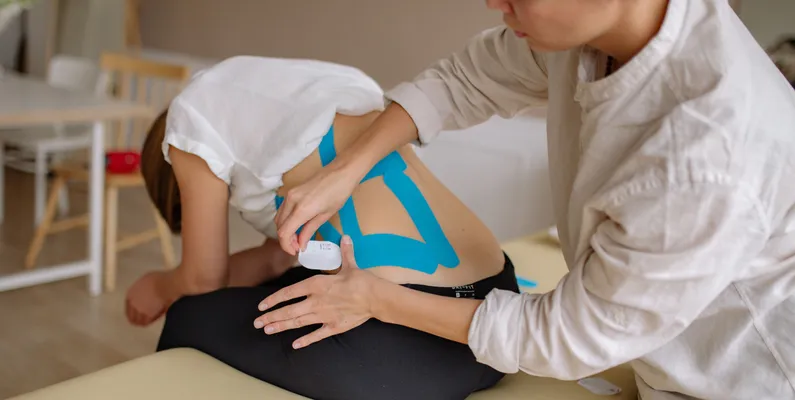 Pain management specialist reviewing a spine model in Portsmouth, NH