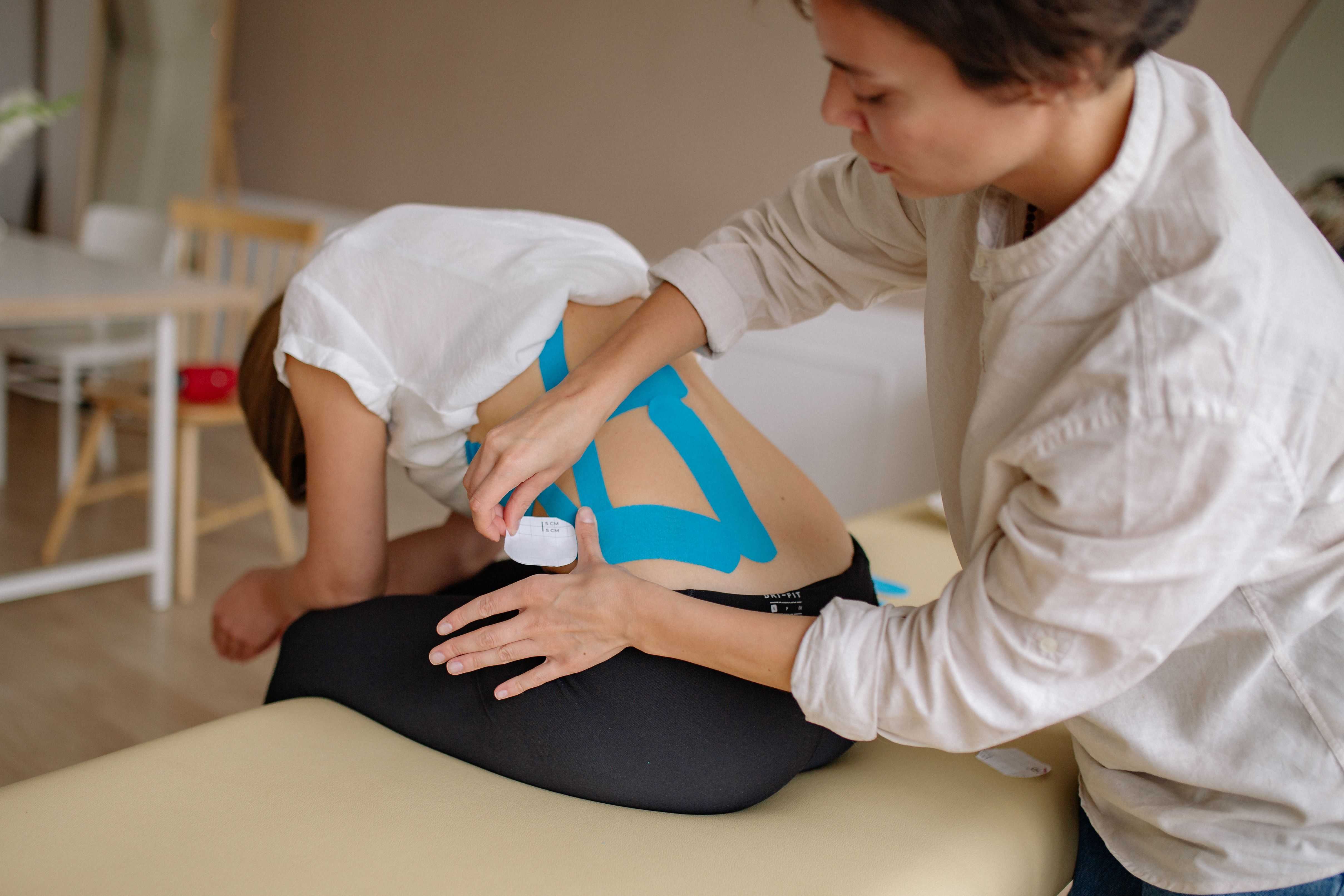 Pain management specialist reviewing a spine model in Portsmouth, NH